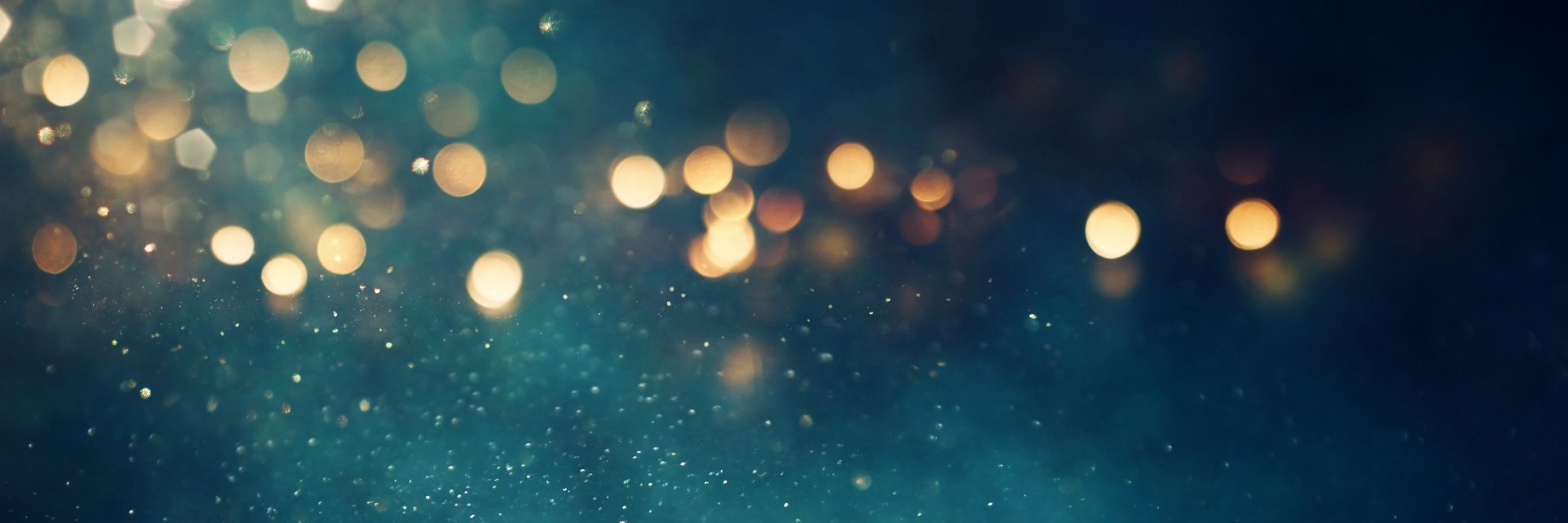 background of abstract glitter lights. gold, blue and black. de focused. banner